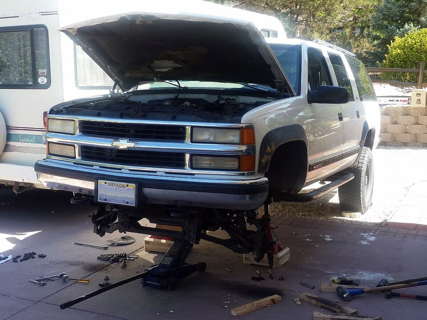 A car raised on a jack during a roadside repair